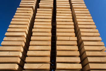 Fototapeta premium Stack of new wooden studs at the lumber yard