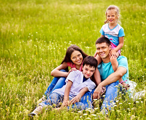 Fototapeta premium Family on green grass.