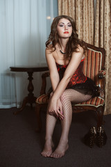 Naklejka premium Beautiful sexy woman sitting on chair