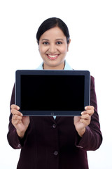 Happy young business woman showing tablet