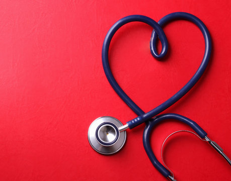 Stethoscope isolated on red background.