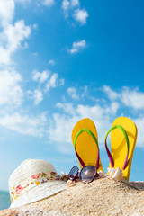 Summer beach vacation with flip flop, sunglasses and floppy hat