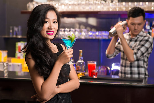 Asian woman with a drink