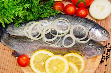 two rainbow trout with lemon and fresh vegetables