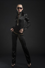 Fototapeta na wymiar Pretty Caucasian woman in black leather catsuit