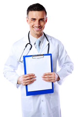 Happy male doctor holding empty clipboard