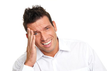 Naklejka premium Angry handsome man in white shirt has a headache