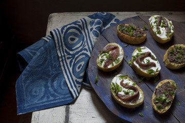 canapes with anchovies and olive paste with fresh parsley