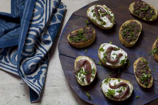 canapes with anchovies and olive paste with fresh parsley