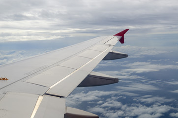 View from a jet plane window high on the blue skies