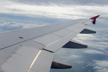 Fototapeta na wymiar View from a jet plane window high on the blue skies