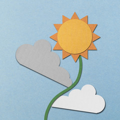 Naklejka premium paper cut of sun and clouds is sunflower on blue sky