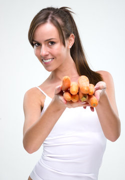 Healthy lifestyle! Beautiful woman holding carrot
