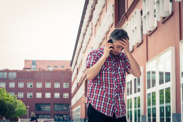 Man in short sleeve shirt talking on phone