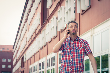 Man in short sleeve shirt talking on phone