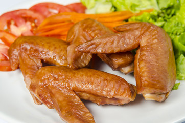 Roasted chicken and vegetables on white background