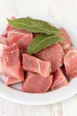 pork with bay leaves on white plate