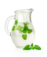 water with ice and mint in a glass jug