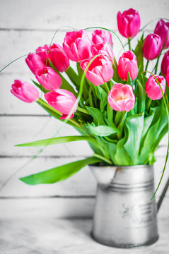 Tulips on wooden rustic background