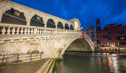 VENICE, ITALY - MAR 23, 2014: Rialto Bridge at sunset with touri
