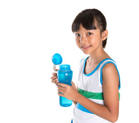 Young girl in sports attire with a bottle of water