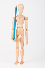 Small wood mannequin standing with colour pencil isolated on whi