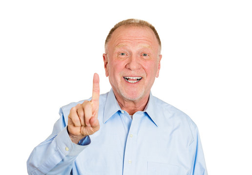 Older man pointing with one sign or up, white background