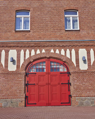 entrance with arched red door and windows, central Europe
