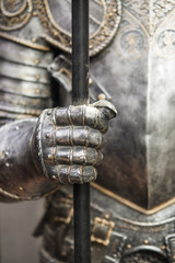 Detail of a medieval knight armor with sword