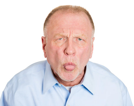 Immature older man sticking his tongue out, showing displeasure