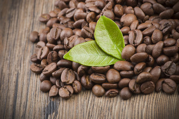 Coffee beans and leaves on the wood table