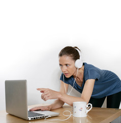 Frau am Computer mit Kopfhörer