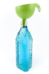 Bottle of water and funnel isolated on white