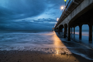 Twilight dusk landscape of pier stretching out into sea with moo © veneratio