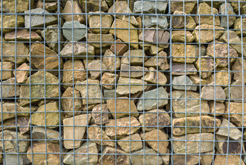 Small chunks of rock behind a mesh fence