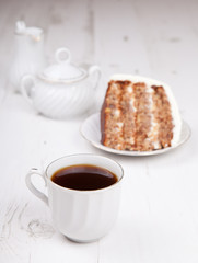 A piece of pecan cake with white buttercream icing