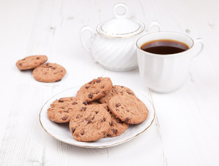 Chocolate chip cookies with coffee on the white table