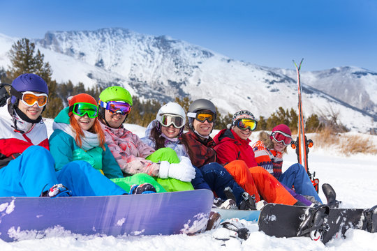 Group of young people with snowboards and goggles