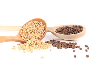 Wooden spoons full with pine nuts.