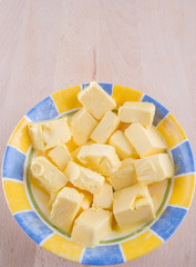 A group of melting butter in a bowl on a pastry board