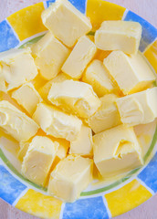 A group of melting butter in a bowl on a pastry board