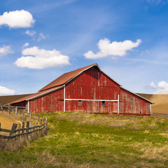 Bright red barn on clear day.