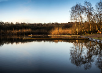 Obraz premium Stunning Spring sunrise landscape over lake with reflections and