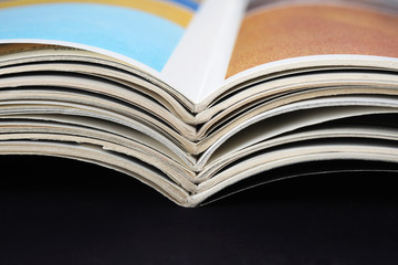 pile of old magazines with bending pages