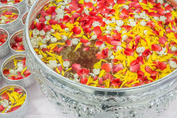 Water with jusmine and roses corolla in bowl for Songkran festiv