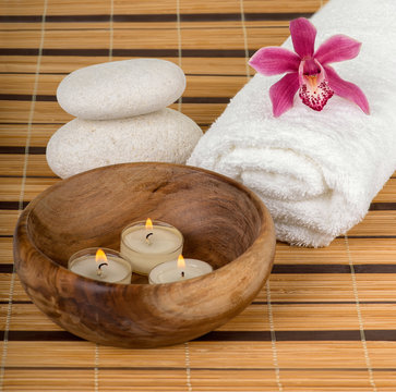Spa decoration with candles, orchid and spa stones