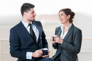 Businessman and woman talking over coffee break