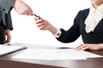 Businesswoman giving the pen and the contract to sign