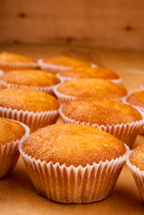 Close-up of cupcakes on wooden board.