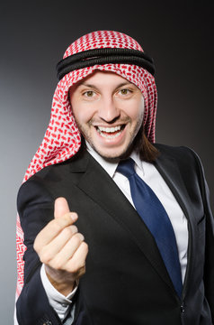 Arab businessman in delight against grey background